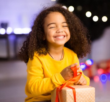 Child smiling while opening present