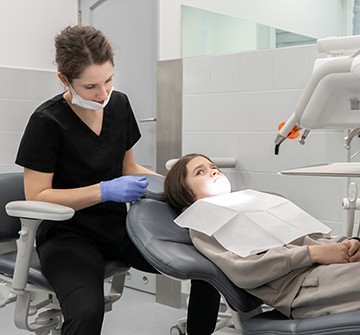 a child sitting in a treatment chair