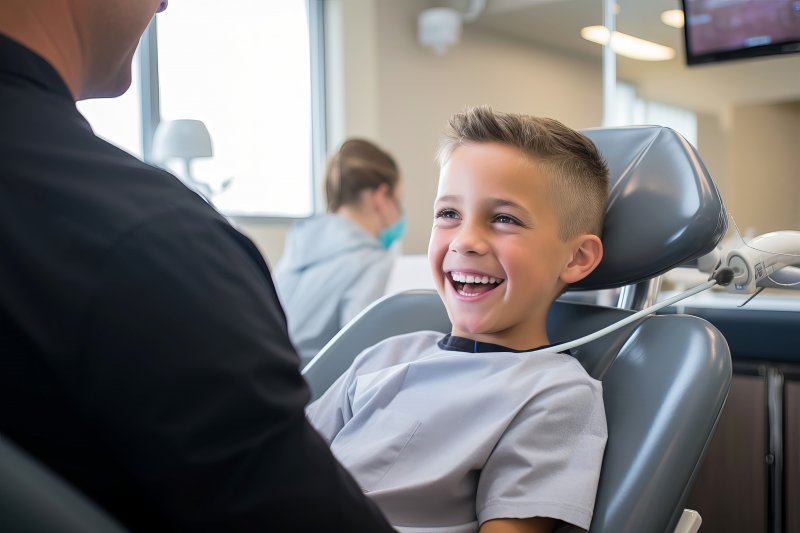 young boy in dentist’s chair smiling